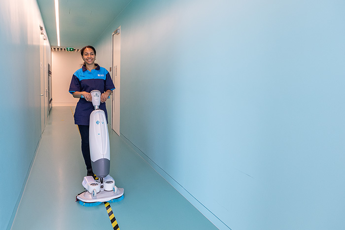 Bidvest Noonan cleaning operative using equipment in an education setting
